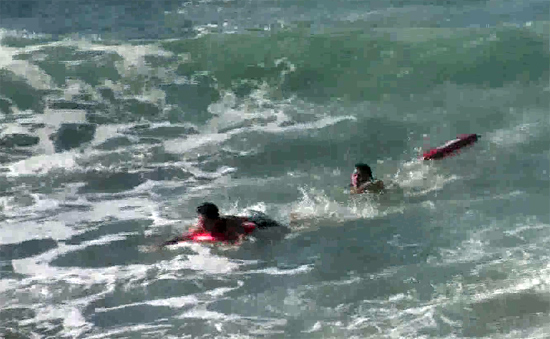 제주 서귀포시 중문색달해변에서 발행한 이안류에 피서객이 떠밀려 가자 해경 대원이 구조하고 있다.